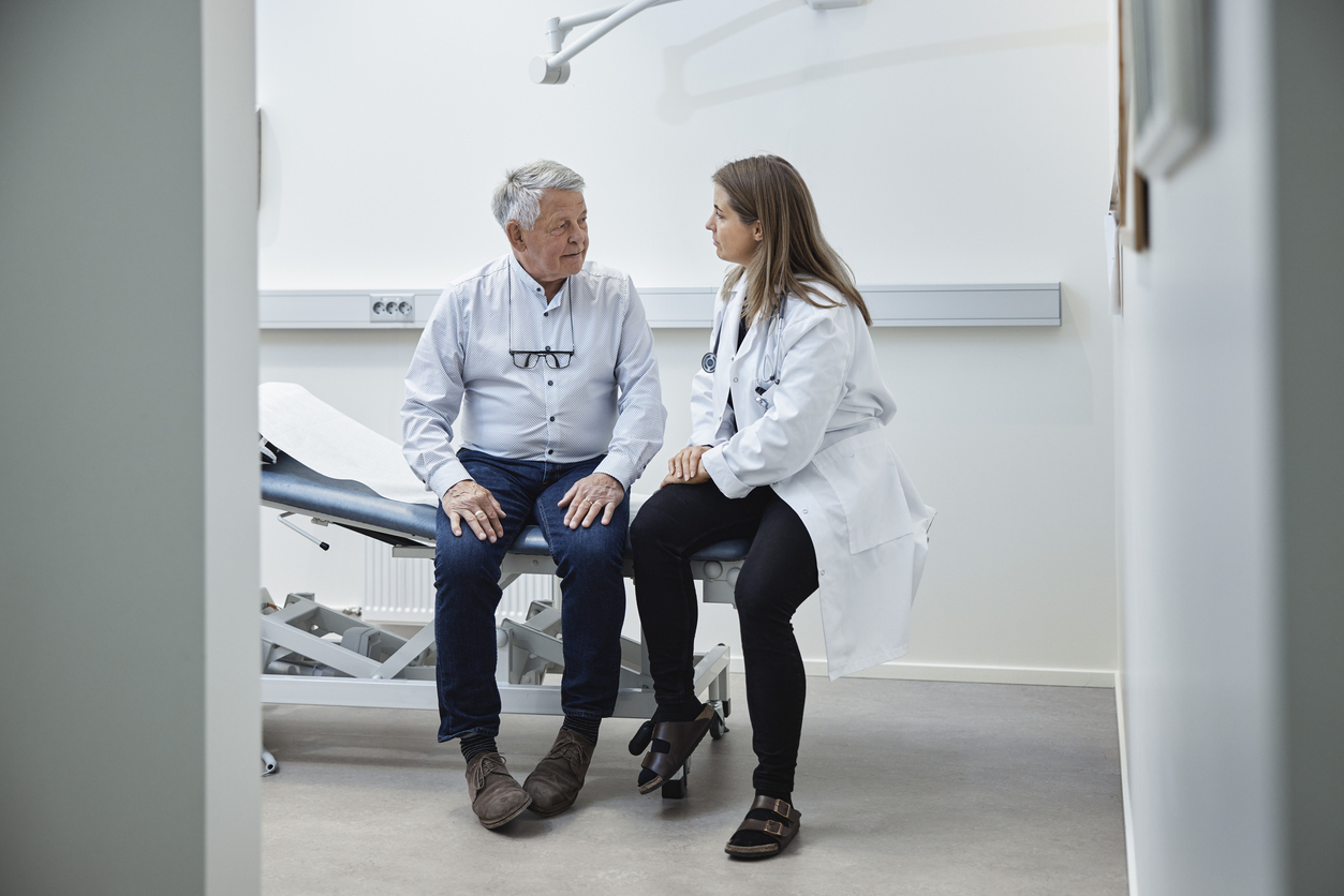 Spine surgeon discusses lumbar deformity diagnosis with patient