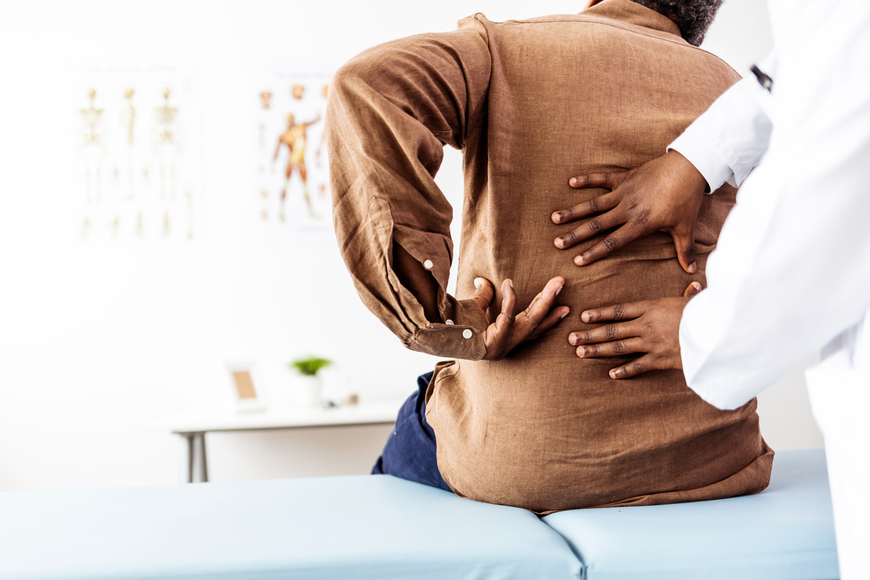 Doctor examines patient’s back