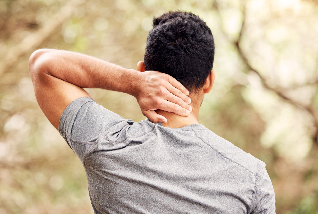 Rear shot of person experiencing neck pain
