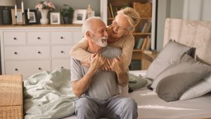 Senior couple embracing in bed