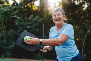Smiling active senior playing pickleball