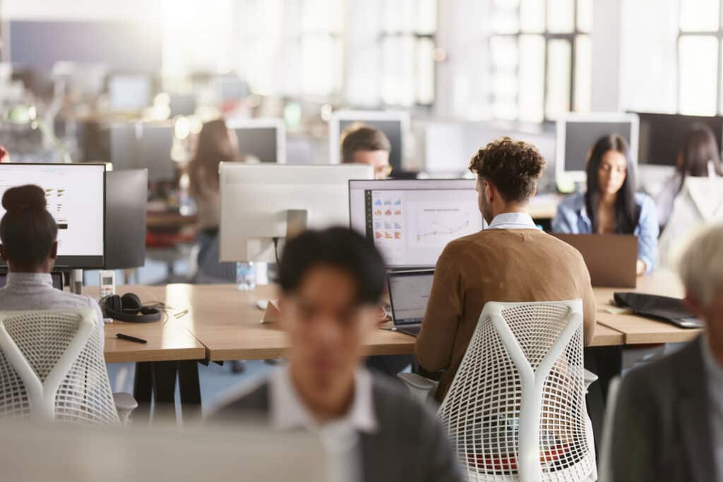 Workers at computers in office