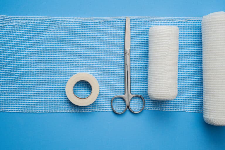 Gauze, tape, and medical scissors for incision care