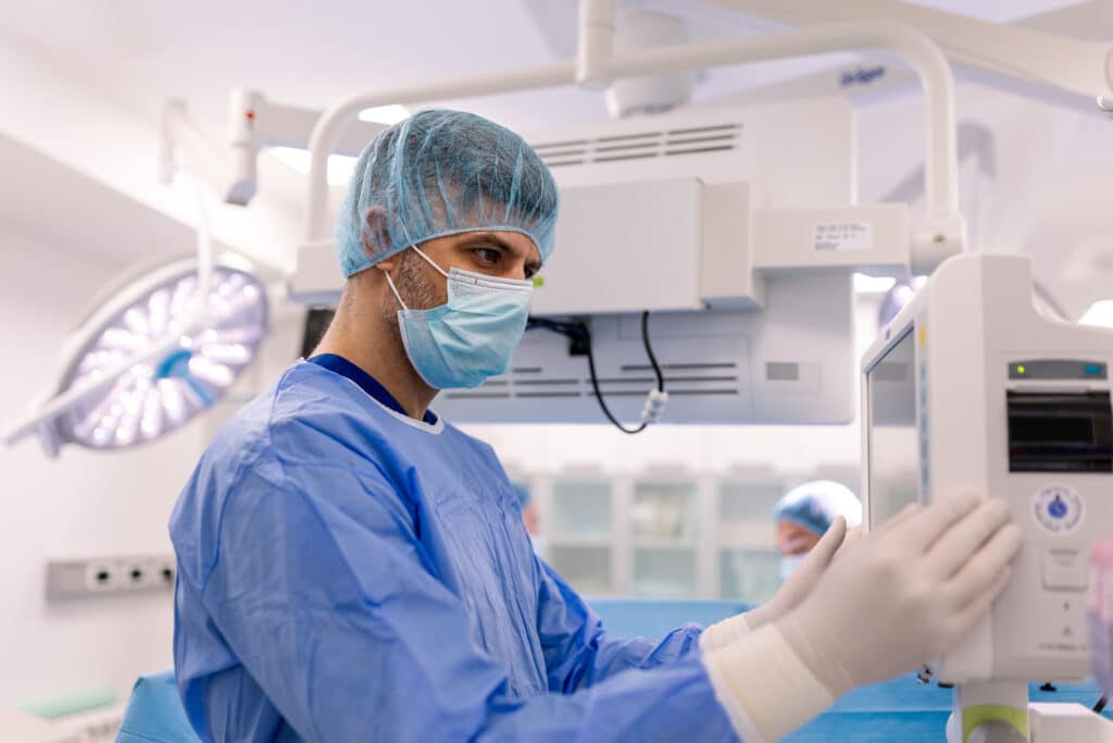 Surgeon looking at monitor in operating room