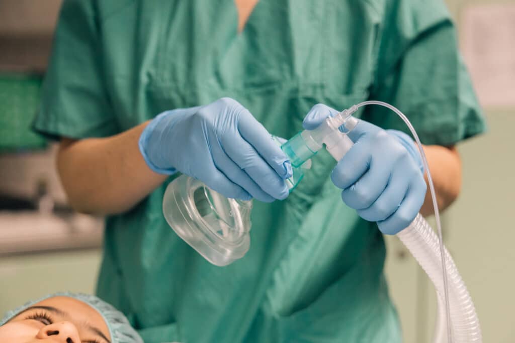 Nurse preparing anesthesia mask in operating room