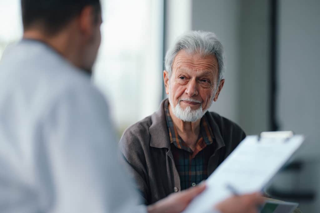 Senior patient consults with doctor