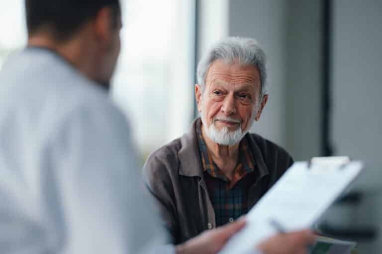 Senior patient consults with doctor