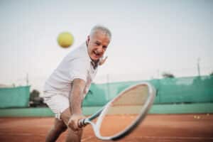 Senior playing tennis