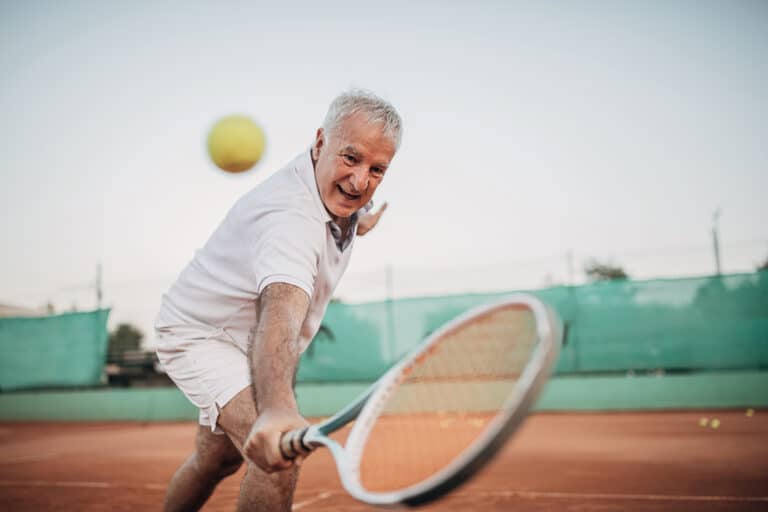 Senior playing tennis